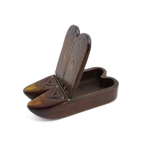 1138 - Treen : A 19thC double shoe snuff box modelled as a pair of shoes with hinged top, carved decoration... 