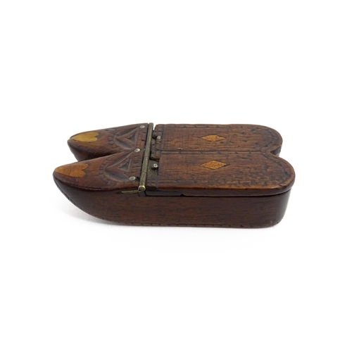 1138 - Treen : A 19thC double shoe snuff box modelled as a pair of shoes with hinged top, carved decoration... 