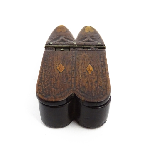 1138 - Treen : A 19thC double shoe snuff box modelled as a pair of shoes with hinged top, carved decoration... 