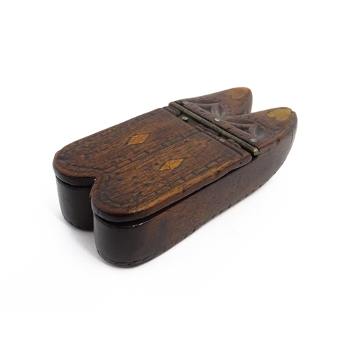 1138 - Treen : A 19thC double shoe snuff box modelled as a pair of shoes with hinged top, carved decoration... 