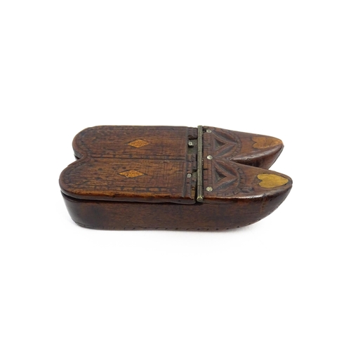 1138 - Treen : A 19thC double shoe snuff box modelled as a pair of shoes with hinged top, carved decoration... 