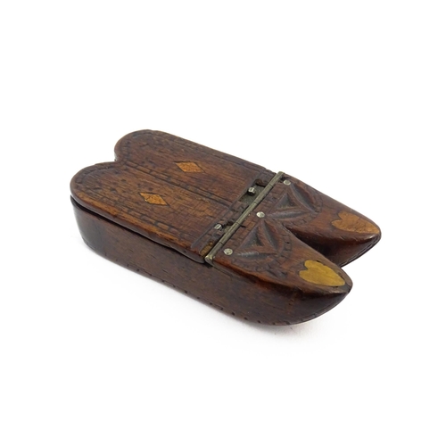 1138 - Treen : A 19thC double shoe snuff box modelled as a pair of shoes with hinged top, carved decoration... 