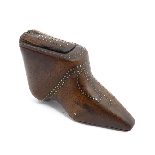 1144 - Treen : A 19thC shoe snuff box of boot form with sliding lid and inlaid brass studwork decoration. A... 