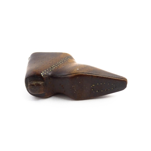 1144 - Treen : A 19thC shoe snuff box of boot form with sliding lid and inlaid brass studwork decoration. A... 