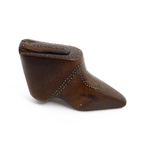 1144 - Treen : A 19thC shoe snuff box of boot form with sliding lid and inlaid brass studwork decoration. A... 