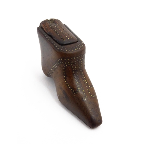 1144 - Treen : A 19thC shoe snuff box of boot form with sliding lid and inlaid brass studwork decoration. A... 