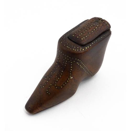 1144 - Treen : A 19thC shoe snuff box of boot form with sliding lid and inlaid brass studwork decoration. A... 