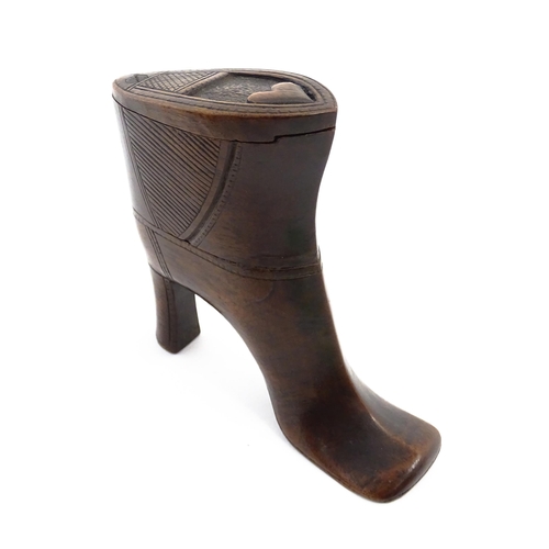 1151 - Treen : A large 19thC shoe snuff box / table snuff of heeled boot form with pivoting lid and carved ... 