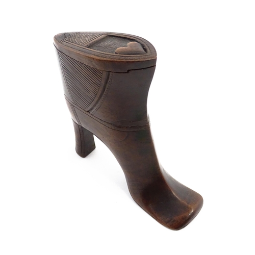 1151 - Treen : A large 19thC shoe snuff box / table snuff of heeled boot form with pivoting lid and carved ... 