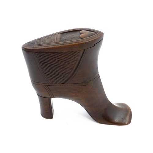 1151 - Treen : A large 19thC shoe snuff box / table snuff of heeled boot form with pivoting lid and carved ... 