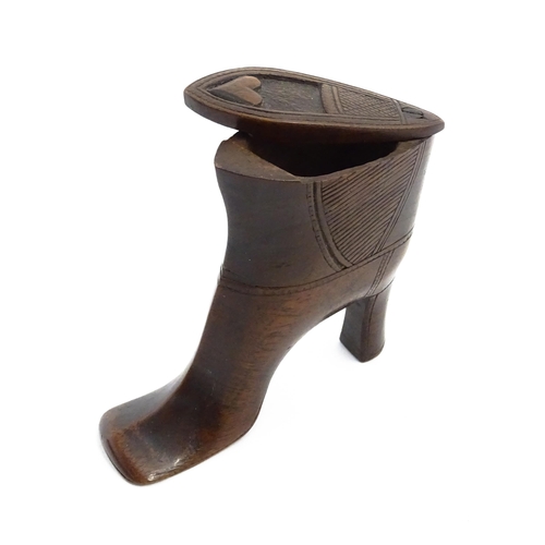 1151 - Treen : A large 19thC shoe snuff box / table snuff of heeled boot form with pivoting lid and carved ... 