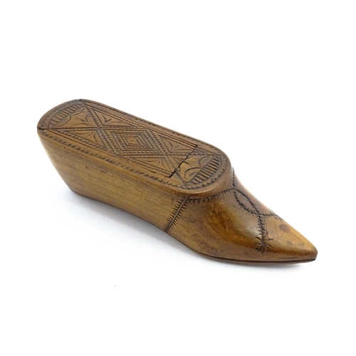 1153 - Treen : A 19thC Continental shoe table snuff box with chip carved decoration to the sliding top. App... 