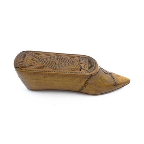 1153 - Treen : A 19thC Continental shoe table snuff box with chip carved decoration to the sliding top. App... 