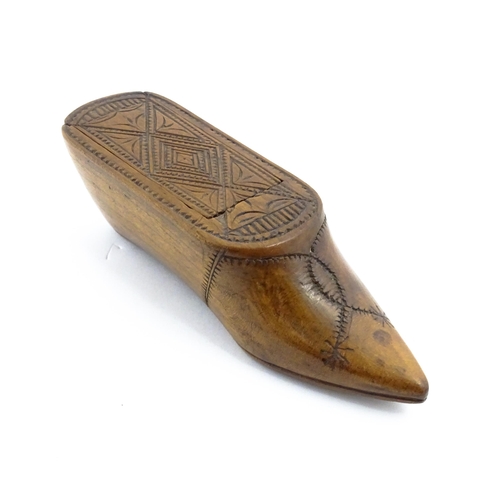 1153 - Treen : A 19thC Continental shoe table snuff box with chip carved decoration to the sliding top. App... 