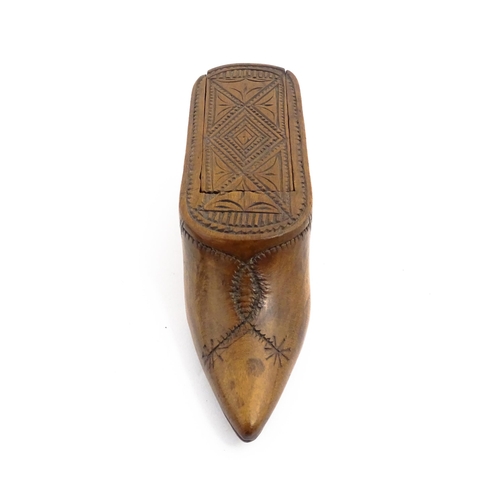 1153 - Treen : A 19thC Continental shoe table snuff box with chip carved decoration to the sliding top. App... 