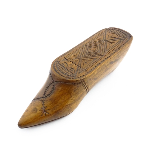 1153 - Treen : A 19thC Continental shoe table snuff box with chip carved decoration to the sliding top. App... 