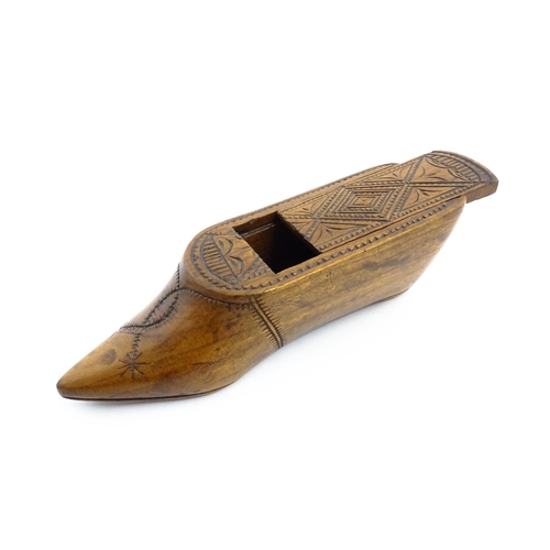 1153 - Treen : A 19thC Continental shoe table snuff box with chip carved decoration to the sliding top. App... 