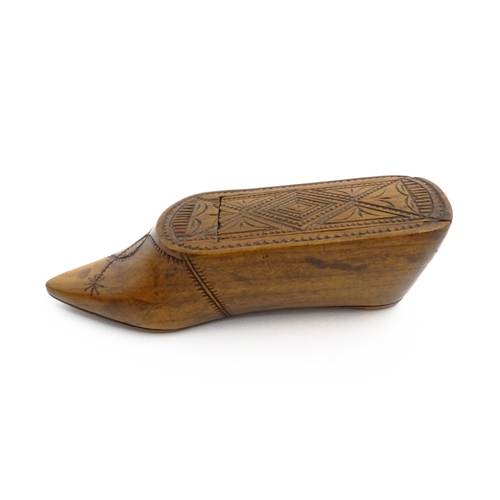 1153 - Treen : A 19thC Continental shoe table snuff box with chip carved decoration to the sliding top. App... 