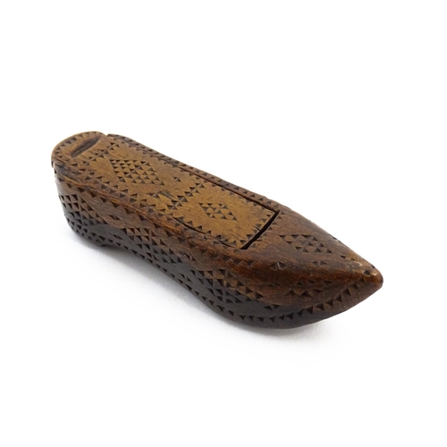 1155 - Treen : A 19thC Continental shoe snuff box with sliding lid and chip carved decoration. Approx. 3 1/... 