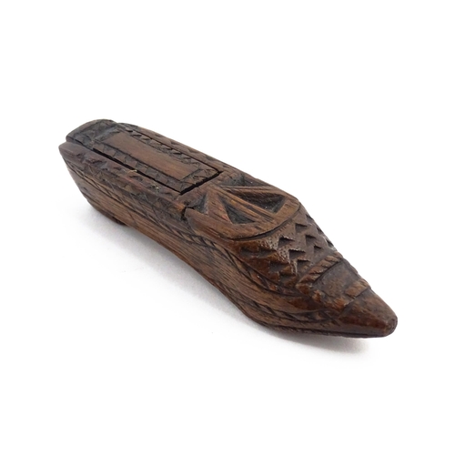 1156 - Treen : A 19thC Continental shoe snuff box with sliding lid and chip carved decoration. Approx. 4 3/... 