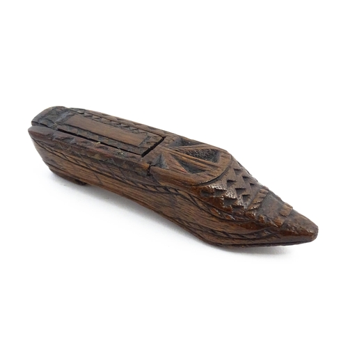 1156 - Treen : A 19thC Continental shoe snuff box with sliding lid and chip carved decoration. Approx. 4 3/... 