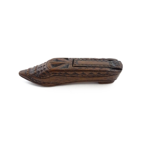 1156 - Treen : A 19thC Continental shoe snuff box with sliding lid and chip carved decoration. Approx. 4 3/... 