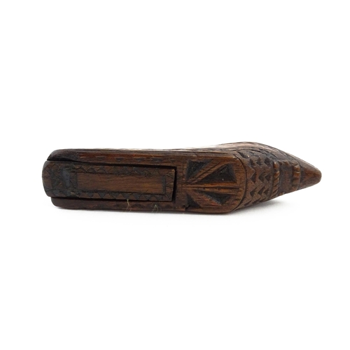 1156 - Treen : A 19thC Continental shoe snuff box with sliding lid and chip carved decoration. Approx. 4 3/... 