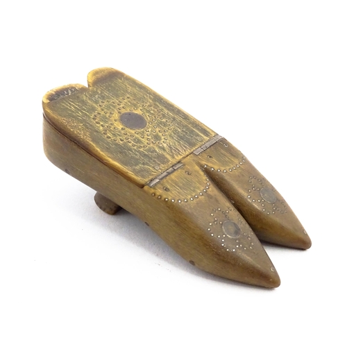 1158 - A 19thC horn double shoe snuff box modelled as a pair of shoes with hinged top and inlaid brass stud... 