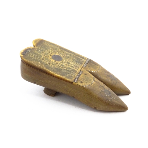 1158 - A 19thC horn double shoe snuff box modelled as a pair of shoes with hinged top and inlaid brass stud... 