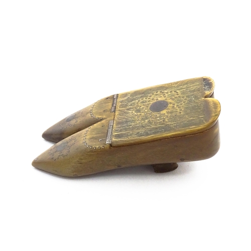 1158 - A 19thC horn double shoe snuff box modelled as a pair of shoes with hinged top and inlaid brass stud... 