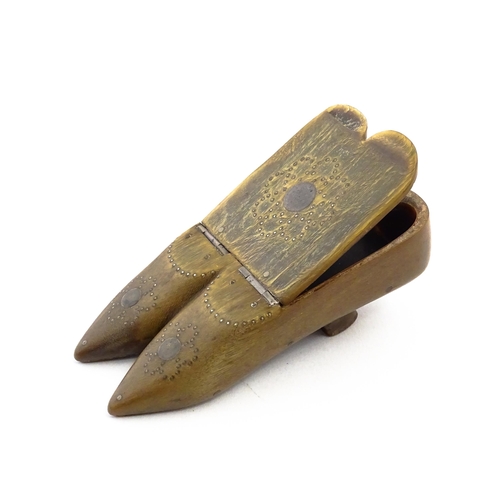 1158 - A 19thC horn double shoe snuff box modelled as a pair of shoes with hinged top and inlaid brass stud... 