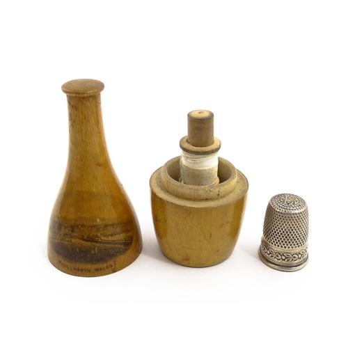 1164 - Sewing Interest: A 19thC Mauchline ware sewing companion comprising needle case, thread spool and th... 