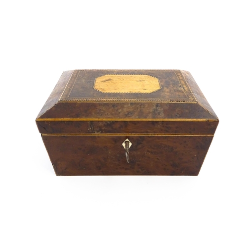 1171 - A 19thC burr yew workbox of tapering form with twin handles, and parquetry inlay to top. Opening to ... 