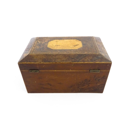 1171 - A 19thC burr yew workbox of tapering form with twin handles, and parquetry inlay to top. Opening to ... 