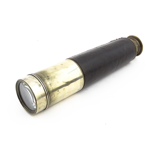 1174 - An early 20thC four-draw stalking monocular telescope by Dolland of London, with leather cover, sun ... 