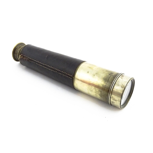 1174 - An early 20thC four-draw stalking monocular telescope by Dolland of London, with leather cover, sun ... 