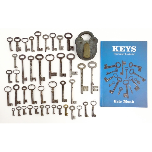 1183 - A quantity of assorted old keys, and a Tumbler padlock. Together with a book titled Keys Their Histo... 