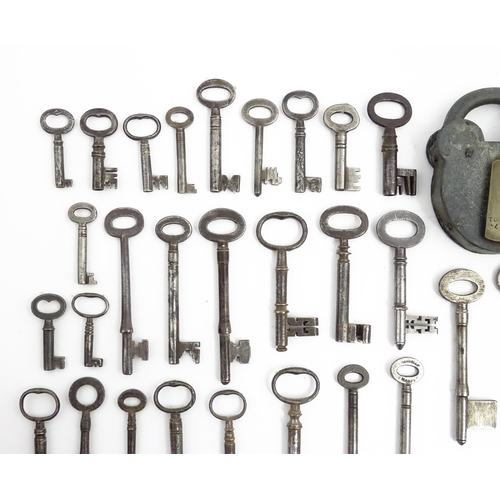 1183 - A quantity of assorted old keys, and a Tumbler padlock. Together with a book titled Keys Their Histo... 