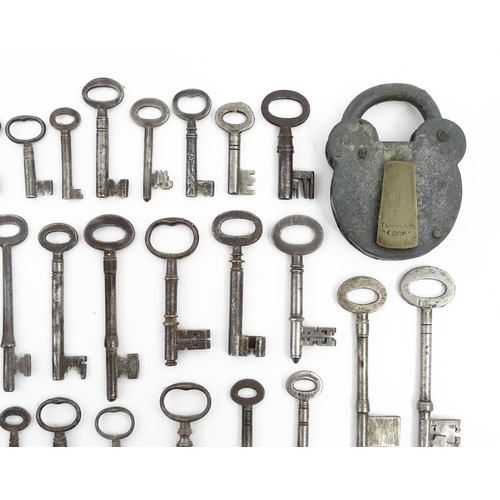 1183 - A quantity of assorted old keys, and a Tumbler padlock. Together with a book titled Keys Their Histo... 