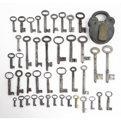 1183 - A quantity of assorted old keys, and a Tumbler padlock. Together with a book titled Keys Their Histo... 