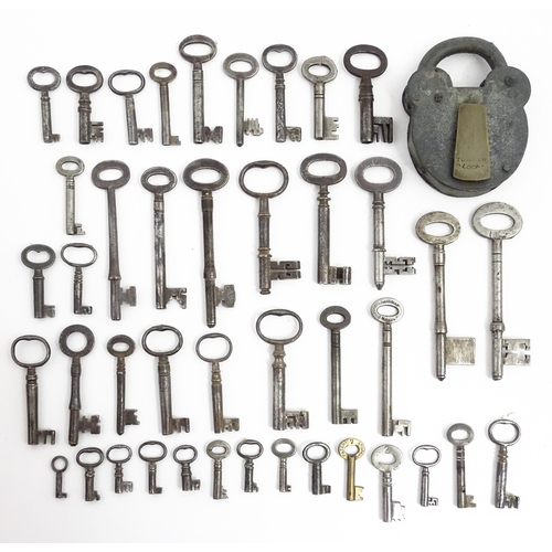 1183 - A quantity of assorted old keys, and a Tumbler padlock. Together with a book titled Keys Their Histo... 