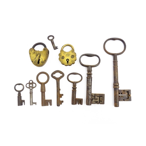 1184 - A quantity of assorted old keys. Together with a Victorian padlock, and another of shaped form with ... 