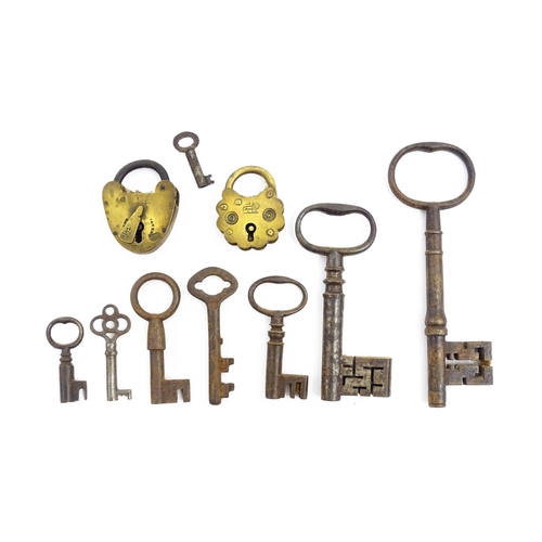 1184 - A quantity of assorted old keys. Together with a Victorian padlock, and another of shaped form with ... 