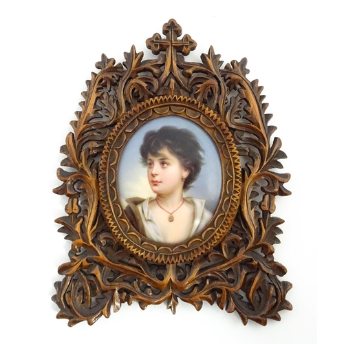 1188 - Three late 19th / early 20thC frames comprising a Black Forest style carved wooden frame with a hand... 