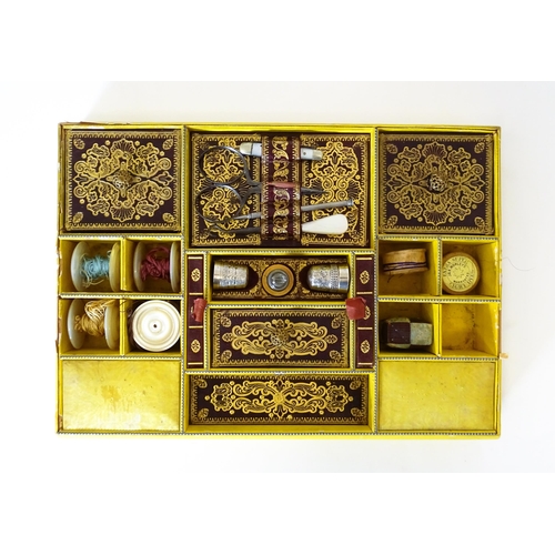 1194 - A Victorian rosewood sewing box / workbox of sarcophagus form with twin ring handles, opening to rev... 