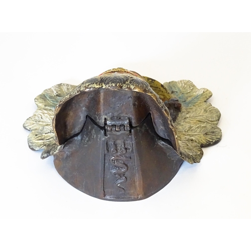 1199 - A late 20thC cast novelty inkwell formed as a Native American Indian with headdress. Approx. 4 1/4