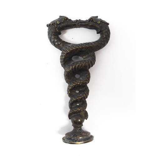 1204 - A 19thC cast desk / hand seal formed as two intertwined dragons / sea serpents, with monogram to sea... 