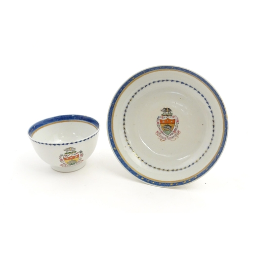 20 - A Chinese famille rose armorial cup and saucer, the armorial with boar in and above a shield, bearin... 