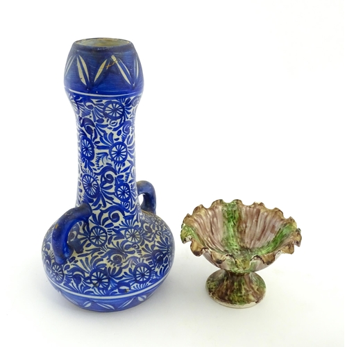 202 - A Moroccan blue and white vase with twin handles decorated with hand painted flowers. Together with ... 