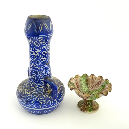 202 - A Moroccan blue and white vase with twin handles decorated with hand painted flowers. Together with ... 